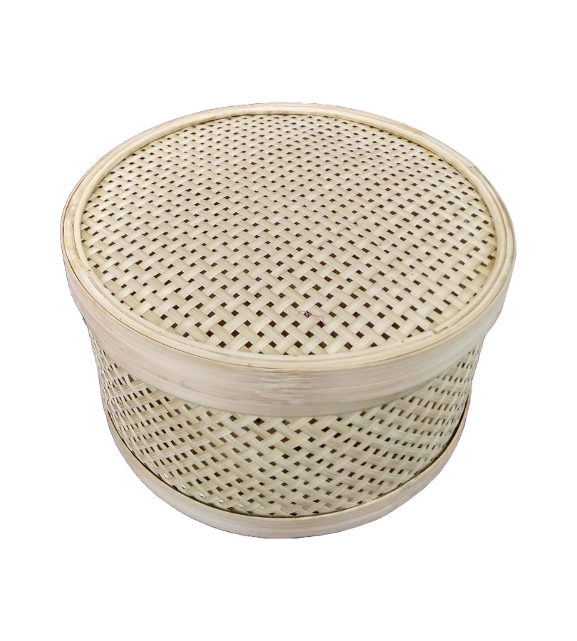 Handmade bamboo chapati box with intricate woven pattern on a striped fabric background